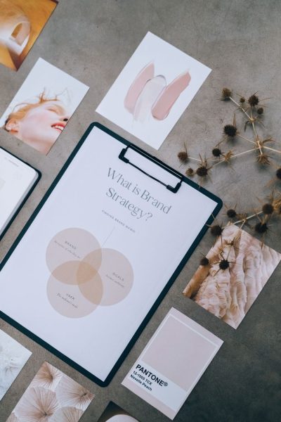 Overhead view of brand strategy documents with artistic visuals for business planning.